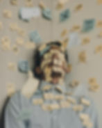 Overwhelmed person at work, surrounded by sticky notes reminding them to practice self-care and reduce job misalignment.