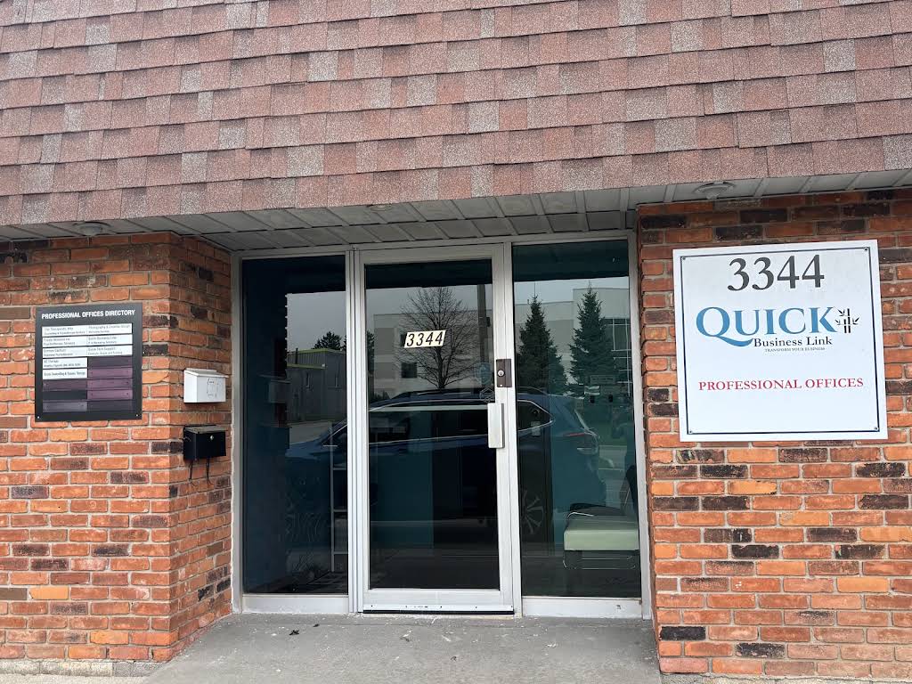 Entrance to 3344 Mainway, with glass doors and the Quick Business Link professional offices sign
